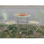 A three piece light green painted folding steel garden terrace set with decorative pierced detail,