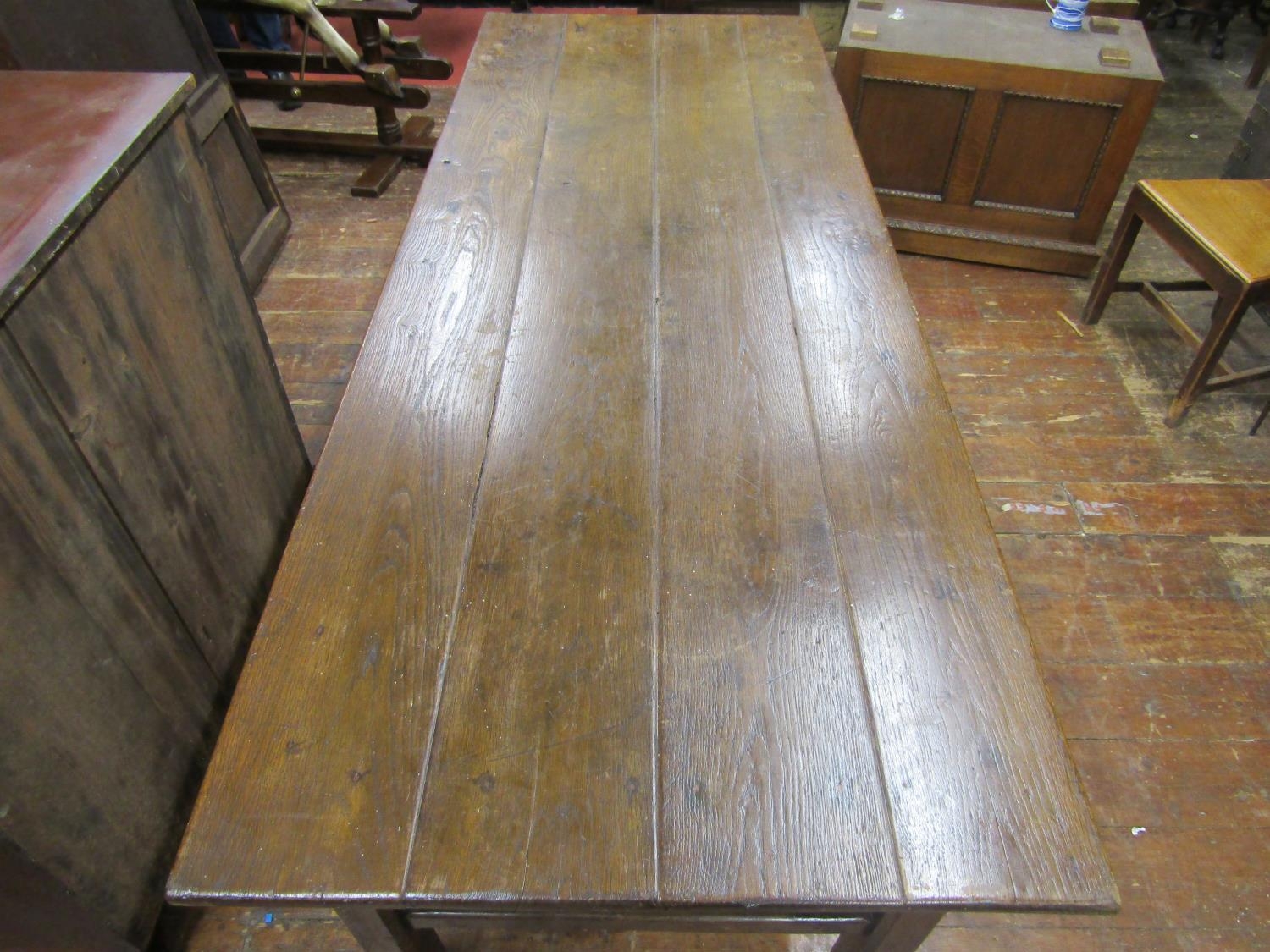 A Georgian oak farmhouse kitchen table, the plank top raised on chaffered supports, united by end - Image 3 of 5