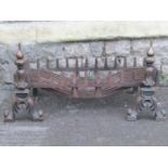 A cast iron fire basket of rectangular form with loose dogs with acanthus detail, basket 75 cm x