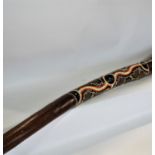 An Australian aboriginal didgeridoo, with a dot painted decoration, 130 cm approximately