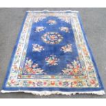A large Chinese wool carpet with a floral pattern, 260cm x 150cm approx
