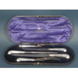 A Goldsmiths & Silversmiths Co Ltd cased set of silver handled pistol grip carving implements with