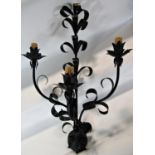 A pair of scrolled wrought iron wall sconces with three branches and foliate detail, 76 cm long