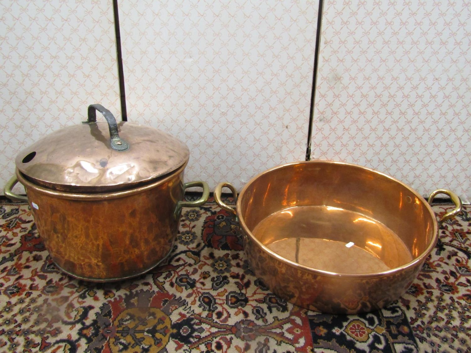 A heavy 19th century copper pot with brass an iron handles, 40cm diameter, together with a large