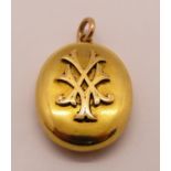 Good quality Victorian yellow metal locket with applied monogram, containing a hand painted portrait
