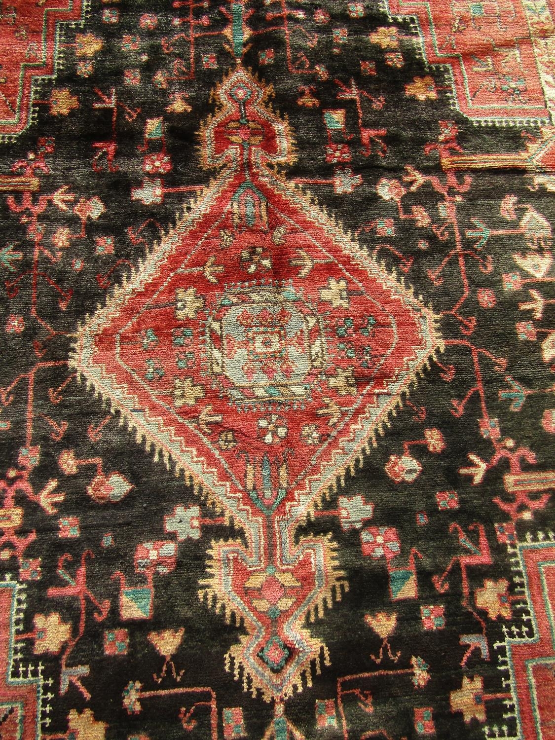 A North West Persian Nahawand rug with lozenge pole medallion and flower and branch motifs on a - Image 2 of 3