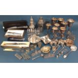 A miscellaneous collection of silver plated items including a cocktail shaker, toast rack, wine