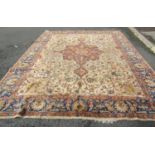 An old Tabriz carpet with an all over floral palmettes on a pale green ground, 343cm x 274cm approx.