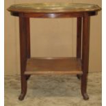 An Eastern oval engraved brass tray top occasional table raised on a mahogany stand with square