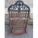 A Victorian cast iron umbrella stand with decorative pierced scrolling foliate detail and