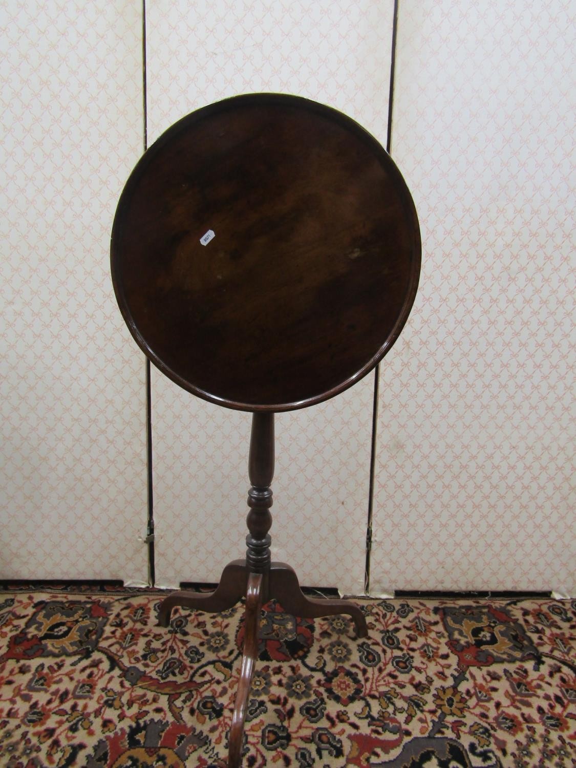 A dainty Georgian walnut dished top occasional table, the circular top 47cm diameter, raised on a