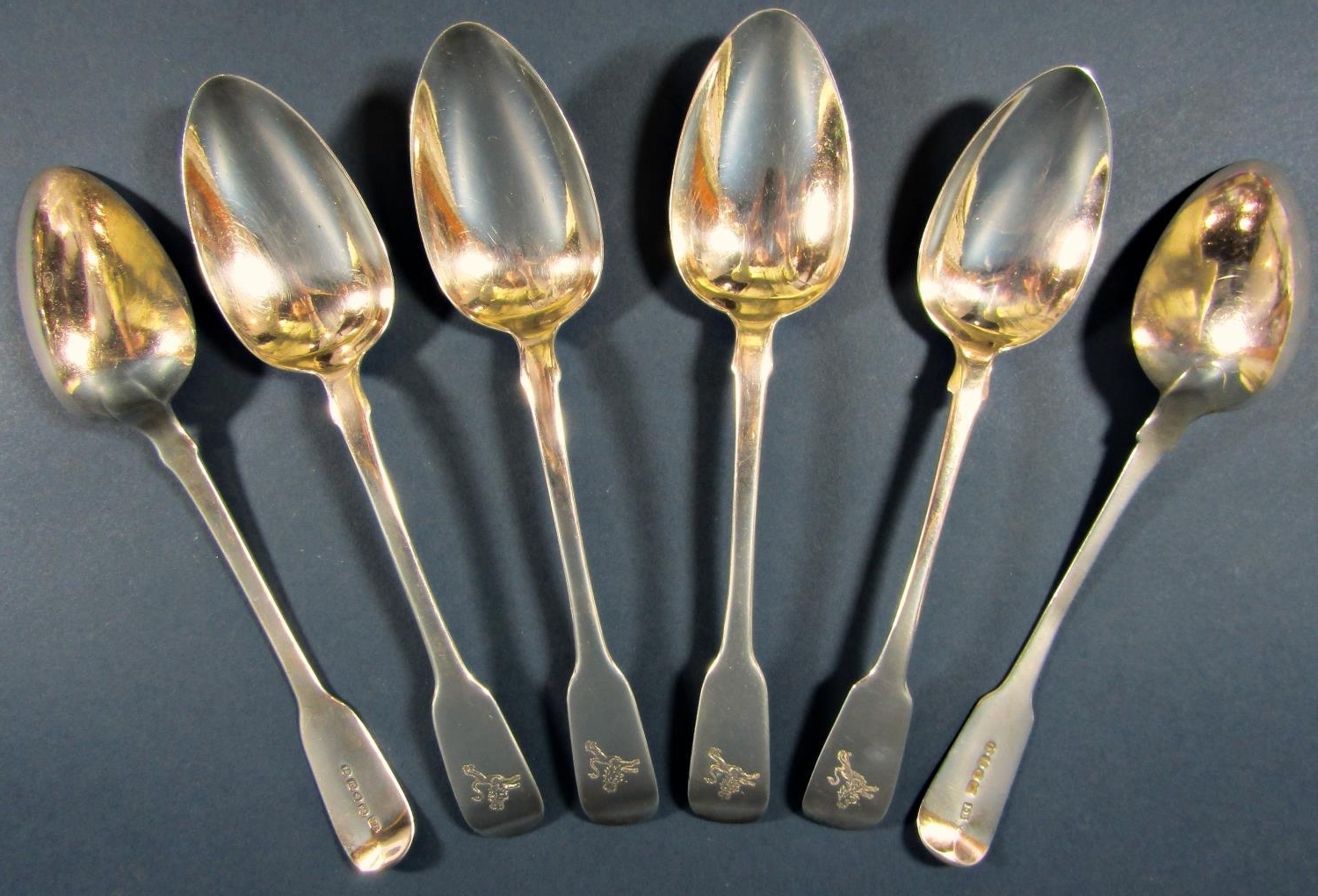 Four Georgian silver serving spoons, London 1825, maker James Beebe, together with two Georgian
