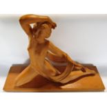 An Art Deco terracotta statue of a semi naked female dancer with an indistinct foundry mark and