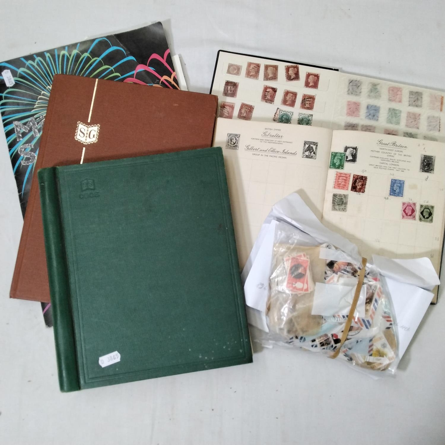 A mixed collection of items to include three albums containing British and worldwide stamps
