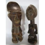 A pair of West African carved wooden figures, a male and a female 29cm and 28cm respectively.