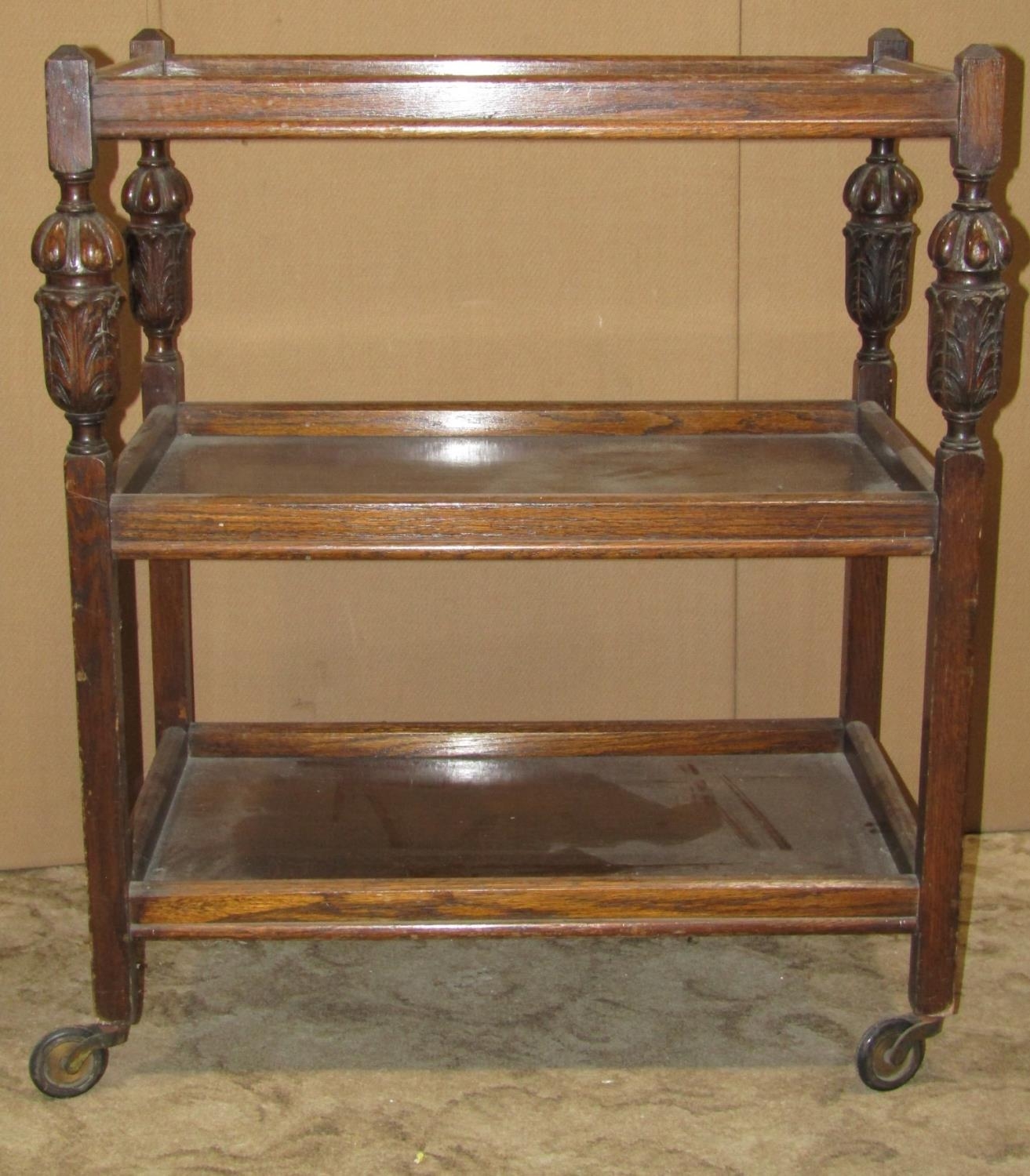 An inlaid Edwardian mahogany occasional table together with a three tier oak tea trolley of