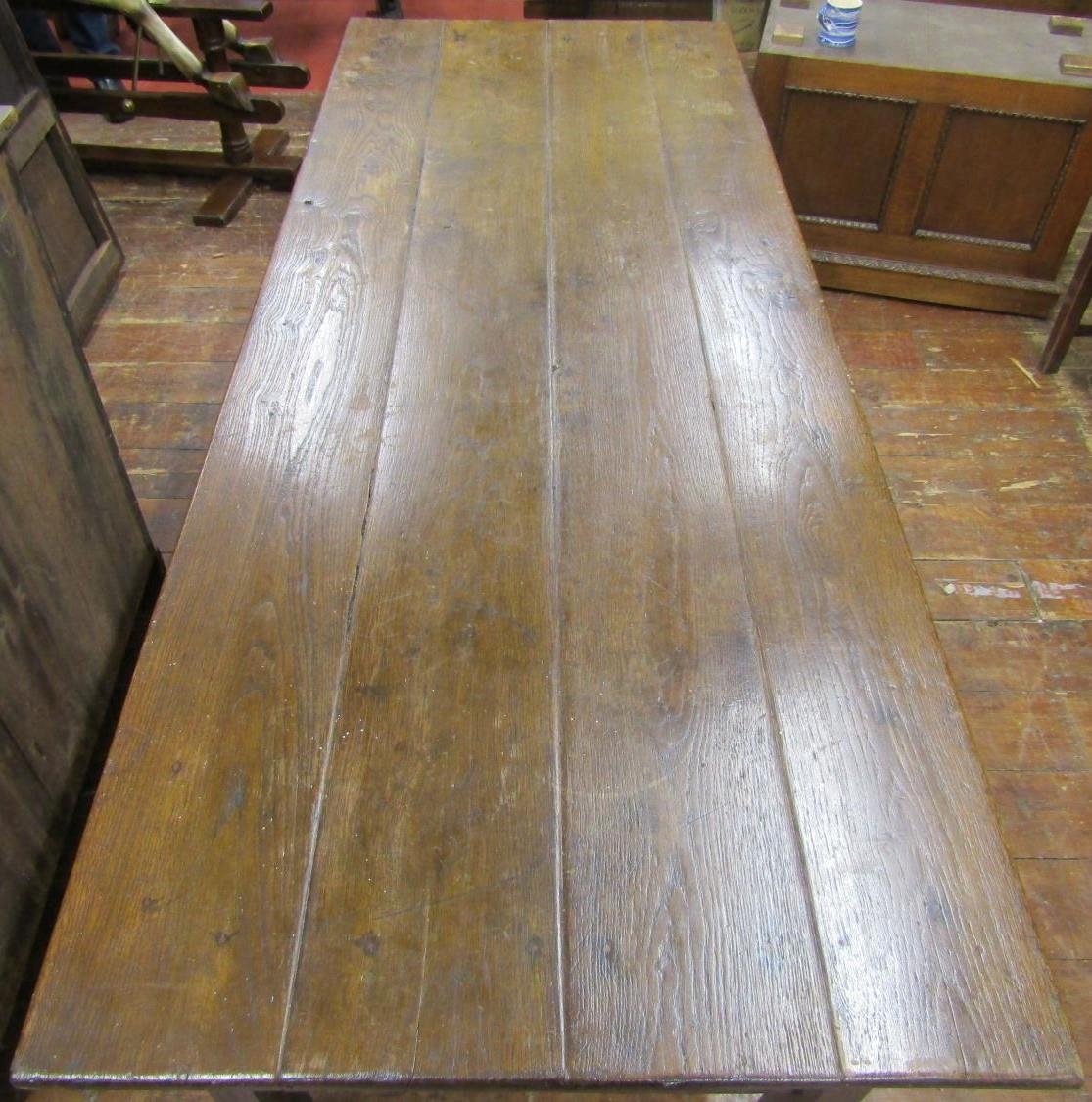 A Georgian oak farmhouse kitchen table, the plank top raised on chaffered supports, united by end - Image 2 of 5