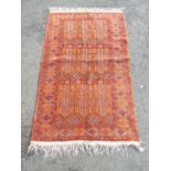 A Persian Bidjar style rug with geometric panels in orange and red tones, 140cm x 82cm approx