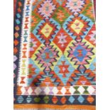 A Chobi kilim with a multi coloured geometric pattern, 152cm x 100cm approx.