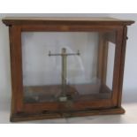 A mahogany Chemists scale with brass scale and a ratcheted glazed front door