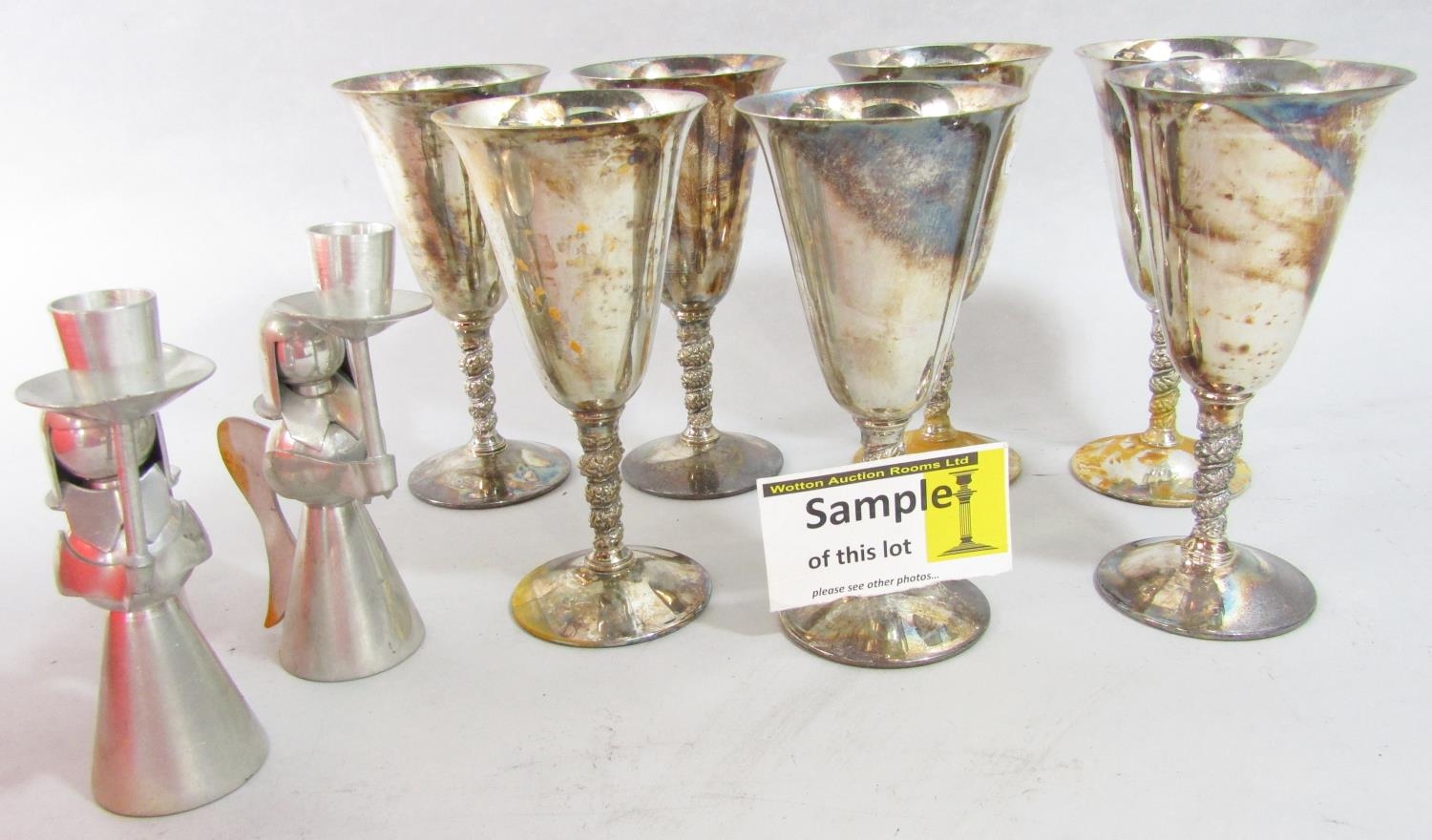 A quantity of Viners stainless steel cutlery, seven metal goblets, and pair of angel candlesticks.