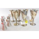 A quantity of Viners stainless steel cutlery, seven metal goblets, and pair of angel candlesticks.