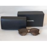 One pair sunglasses by Chanel, unused in black leather case, with booklet, Chanel sealed cleaning