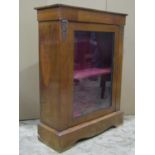 A Victorian walnut veneered pier cabinet with inlaid detail and enclosed by a single rectangular