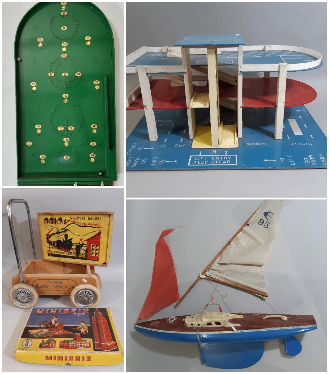 Vintage toys including 'Giner' pond yacht, large multi levelled toy garage, (both for