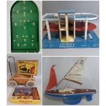Vintage toys including 'Giner' pond yacht, large multi levelled toy garage, (both for