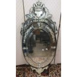 A Venetian style mirror with etched detail, set beneath a shaped and pierced pediment, 120cm high