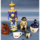 A Royal Doulton figure of Sir Winston Churchill, further smaller example and a McAllum's Whisky