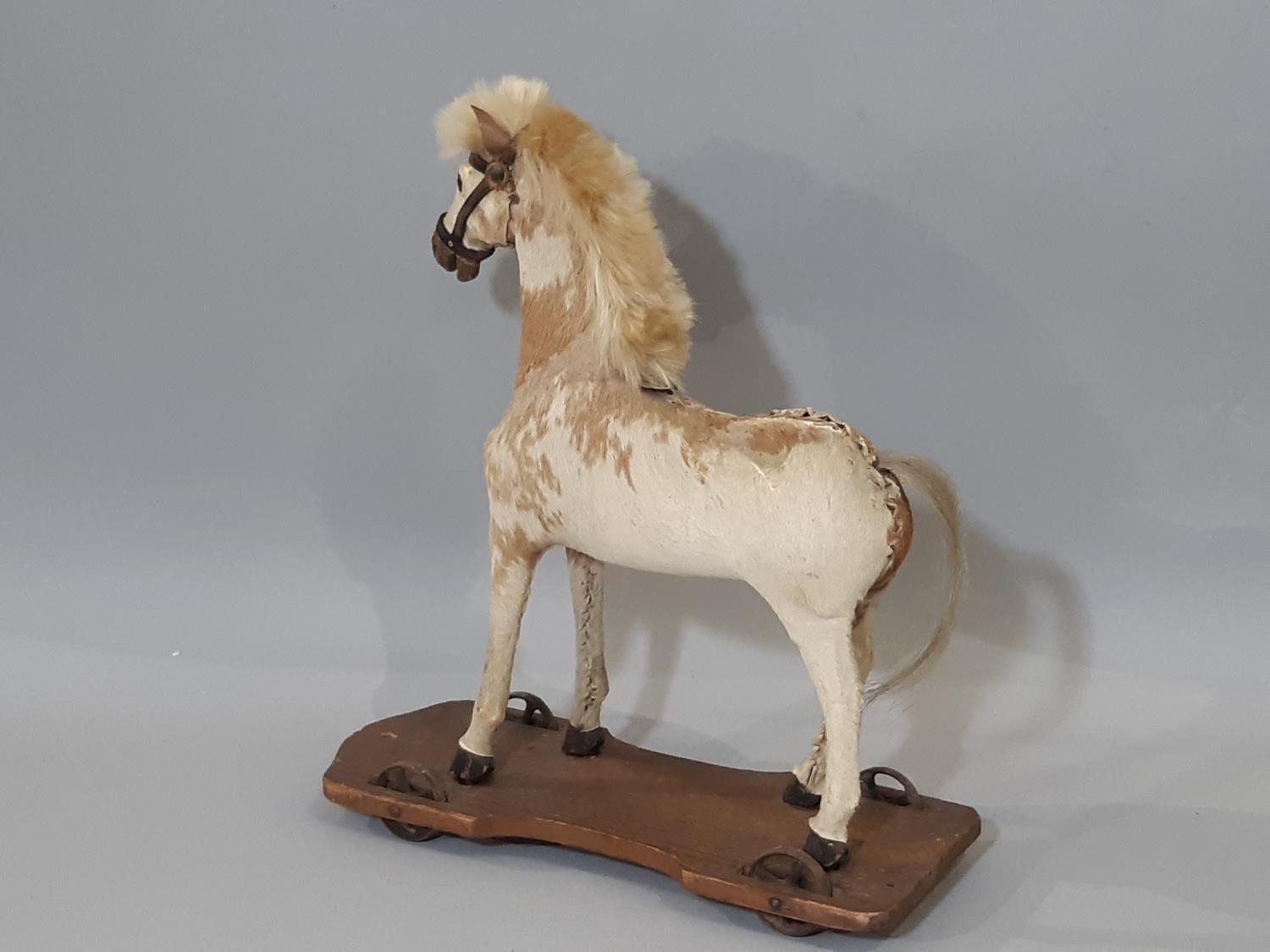 Pull along horse; a small pony skin horse, mounted on a pine base and with metal wheels to each - Image 2 of 4