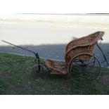 A Victorian bath chair with sprung seat, wire spoke wheels, hard rubber tyres (basket seat for