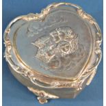 A silver heart shaped trinket box with embossed cupids to the lid, Birmingham 1906 maker Henry