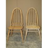 A set of four stripped Ercol Quaker elm and beechwood high hoop and stick back dining chairs