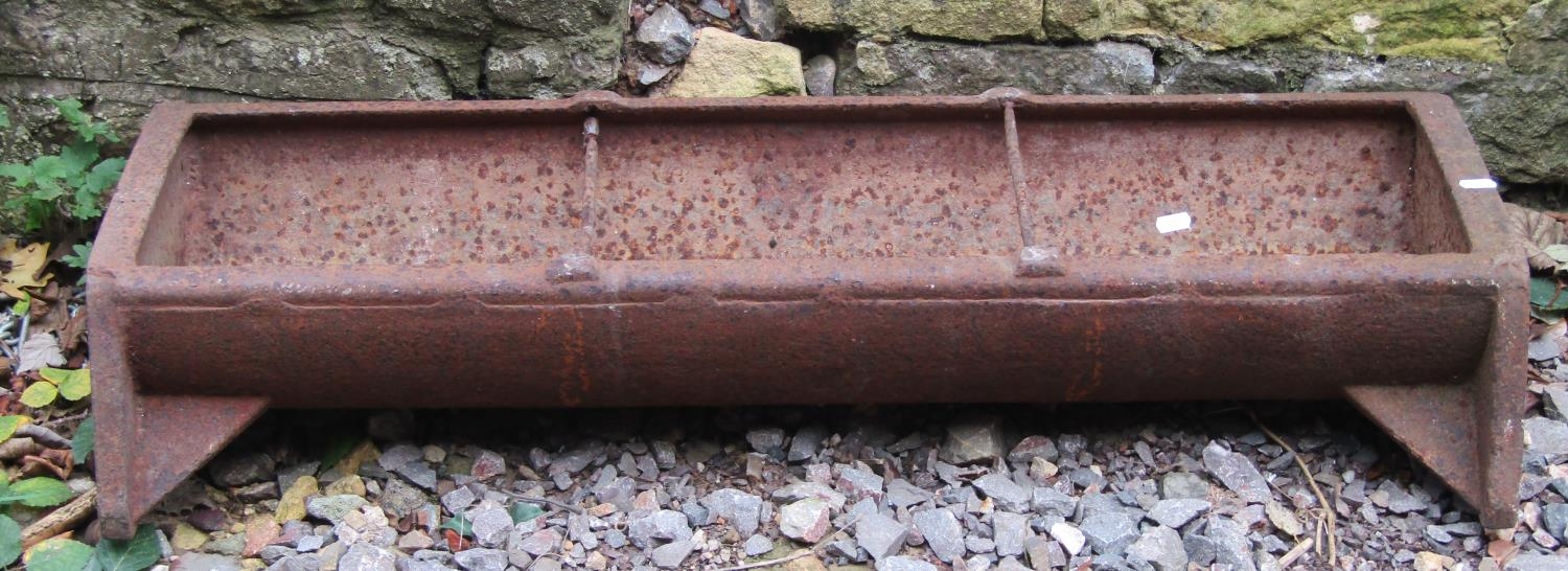 A vintage cast iron pig feeding trough of rectangular form with two simple rung divisions 96 cm long