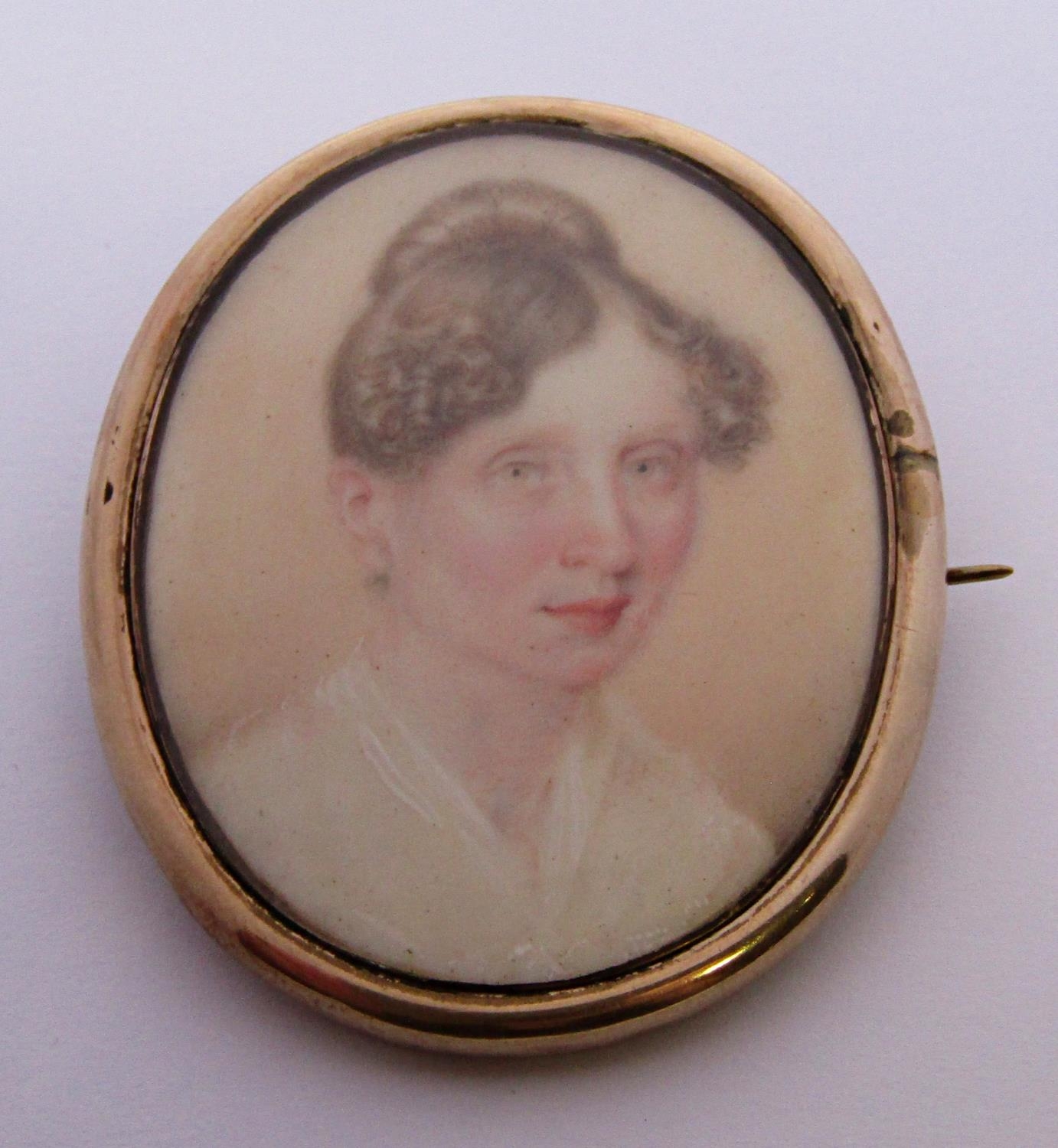 19th century yellow metal mourning brooch with hand painted portrait of a lady, containing plaited