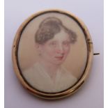 19th century yellow metal mourning brooch with hand painted portrait of a lady, containing plaited