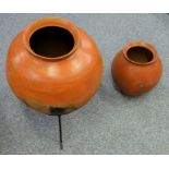African sphericle terracotta pot with a flared rim, Dia. 47 cm on metal stand and a similar