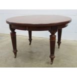 Late Victorian mahogany dining table with a moulded top and semi-circular ends on reeded turned