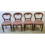 Set of four Victorian carved mahogany balloon backed dining chairs, each with a pink striped seat on