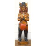 Carved wood North American Indian wearing a feather headdress, standing on a rectangular plinth, H