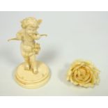Italian carved ivory figure of cupid on a circular pedestal base, H.10cm and an ivory brooch