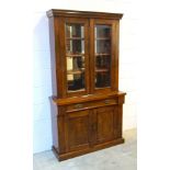Late Victorian walnut cabinet with two glazed panelled doors, enclosing a mirrored back with three