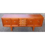 Mid-century teak side board fitted with 3 drawers and four doors on four feet, L. 200 cm