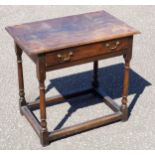 A George III oak hall table, the rectangular top with moulded edge over a frieze drawer on turned