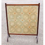 A large early 20th century mahogany framed fire surround screen, embroidered with 16 assorted