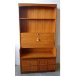 Mid-century teak illuminated display unit fitted with 2 shelves and a drop down door revealing