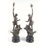 Pair of late 19th century French bronzed spelter figures of a man and a woman, each on a stag, on an
